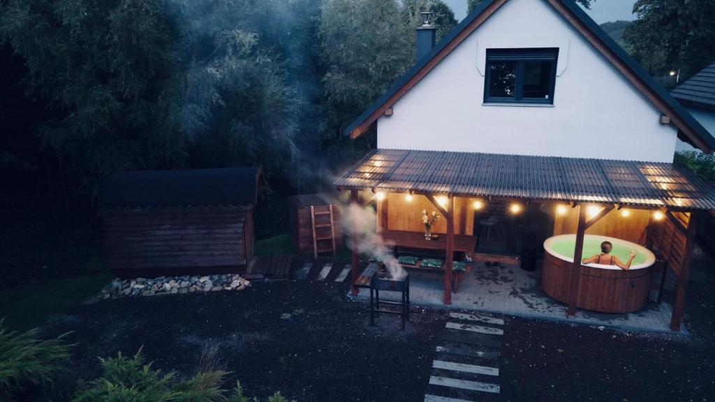 a house with a hot tub in front of a house at Domek wypoczynkowy z sauną i jacuzzi "ELDORADO" in Lubawka