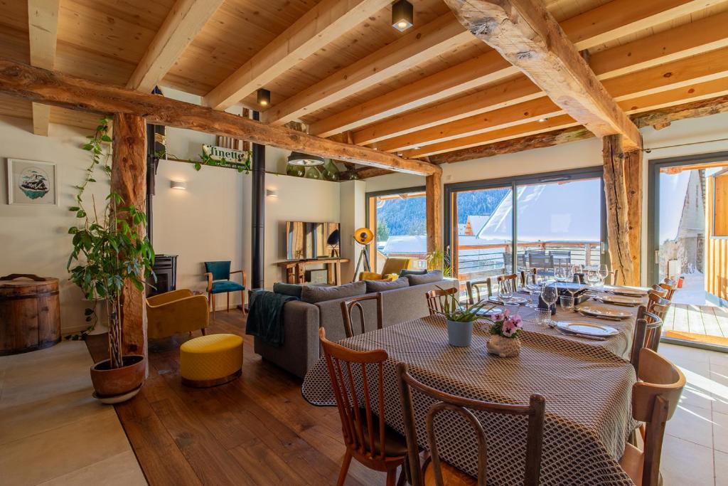 a living room with a table and a couch at Alesina in Montricher-Albanne