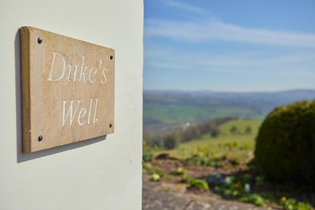 a sign that reads dukes well on a wall at Dukes Well in Congleton