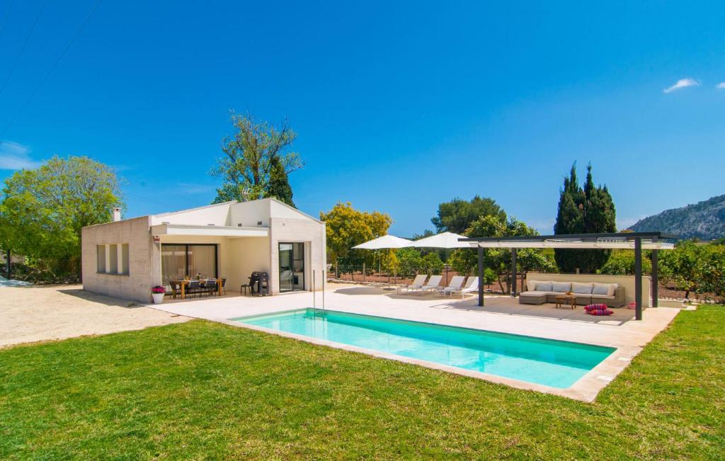 a house with a swimming pool in a yard at Ternelles in Pollença