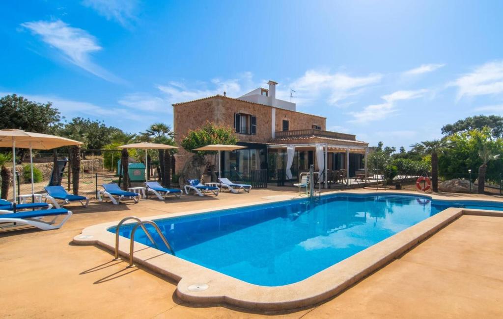 a swimming pool in front of a house at Sa Palmaria Dos in Can Picafort