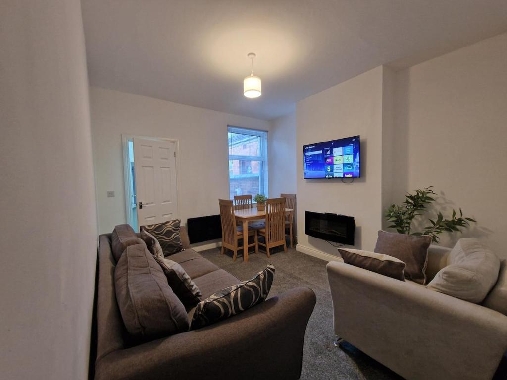 a living room with two couches and a television at Nice Living Serviced Accommodations 14 in Coventry