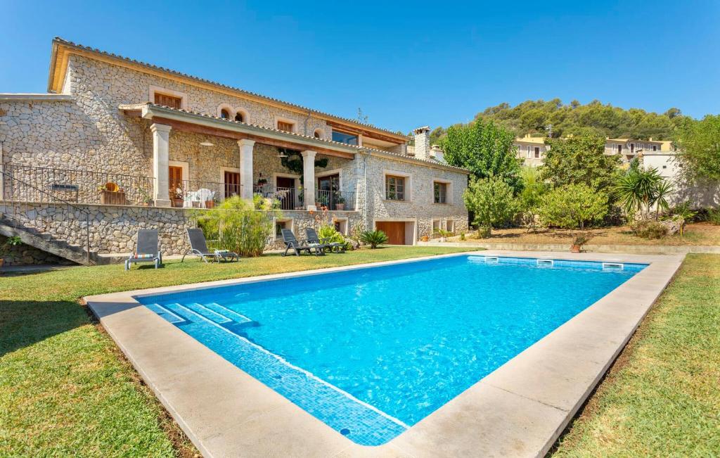 a villa with a swimming pool in front of a house at Turixant Dalt in El Port de la Selva