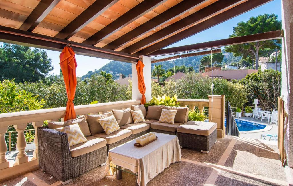 a patio with a couch and a table and a pool at Corazon in Canyamel