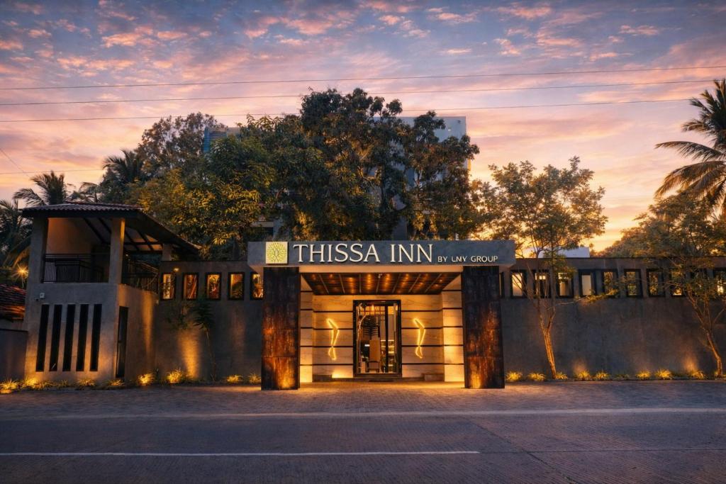 a building with a sign that readsissa inn at Thissa Inn Hotel in Tissamaharama