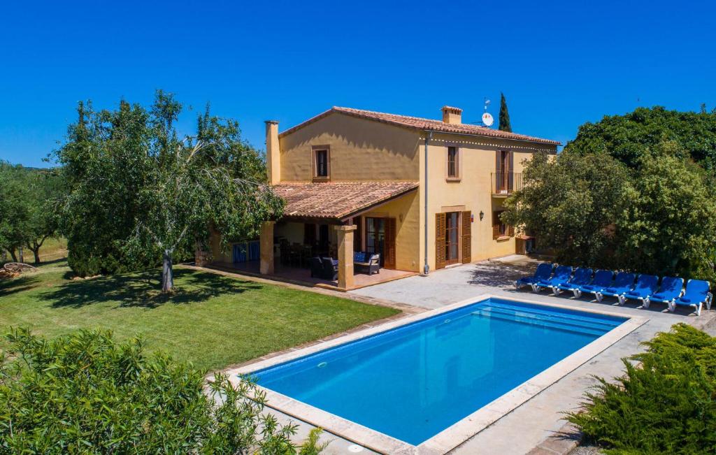 an external view of a villa with a swimming pool at Can Bernat in Cala Mendia