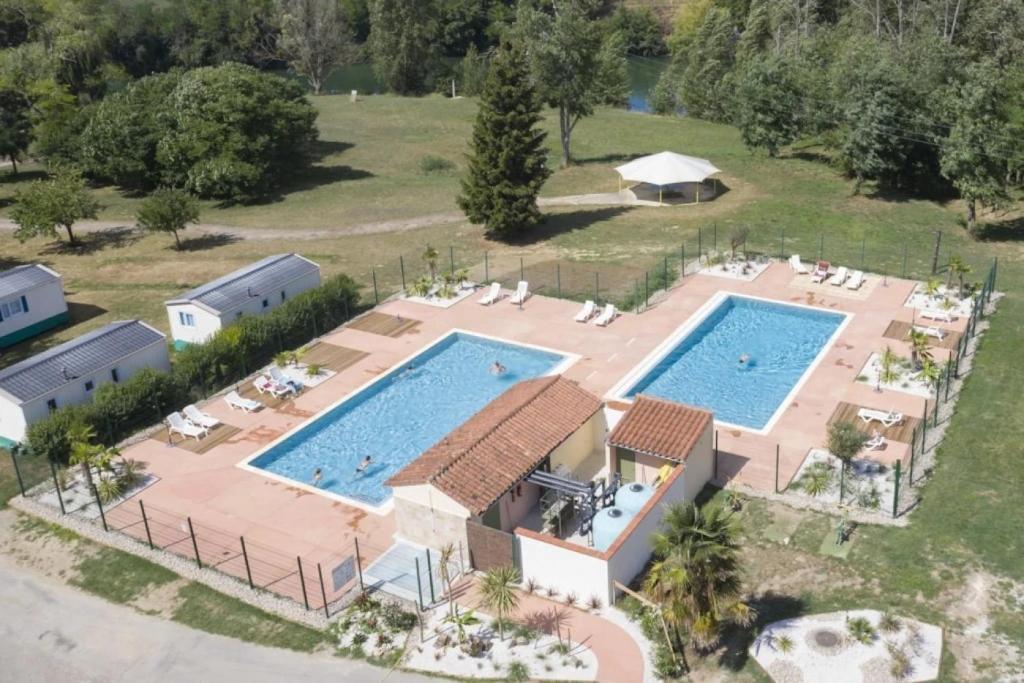 an aerial view of a resort with two swimming pools at ZEcamping 3 étoiles chiens acceptés piscine en bord de rivière avec Canoë in Mazères