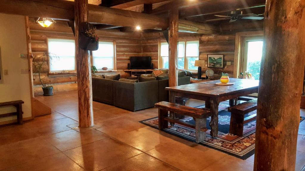 a living room with a table and a couch at Spectacular Large Group Accommodations With Gallatin River Access! in Bozeman