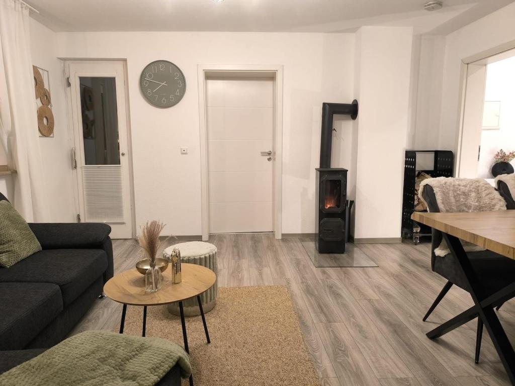 a living room with a couch and a table at Naturnest Berzbuir in Düren - Eifel