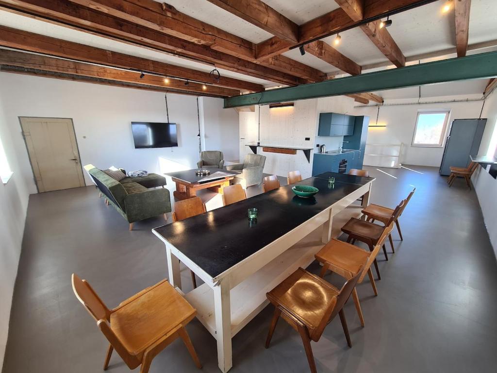 a large living room with a large table and chairs at Loft zum alten Kraftwerk in Herzogenburg
