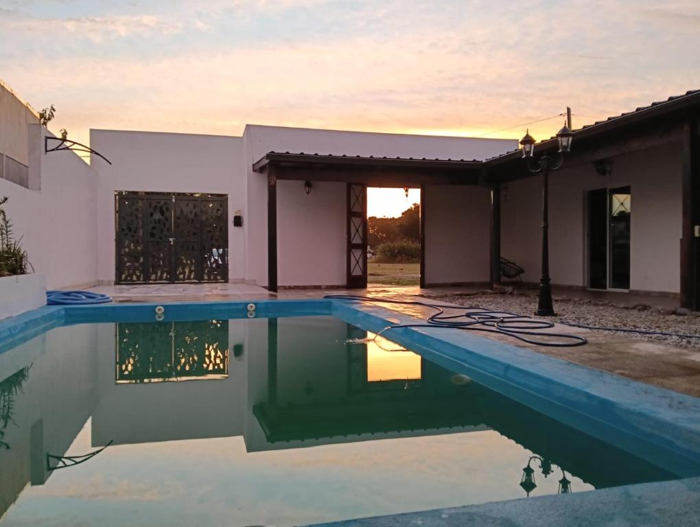 a house with a swimming pool in front of a house at Casa Rincon caleta in Mar de Cobo