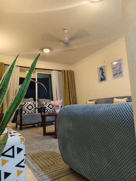a living room with a couch and a table at MoDi's Seaside Nest in Mombasa
