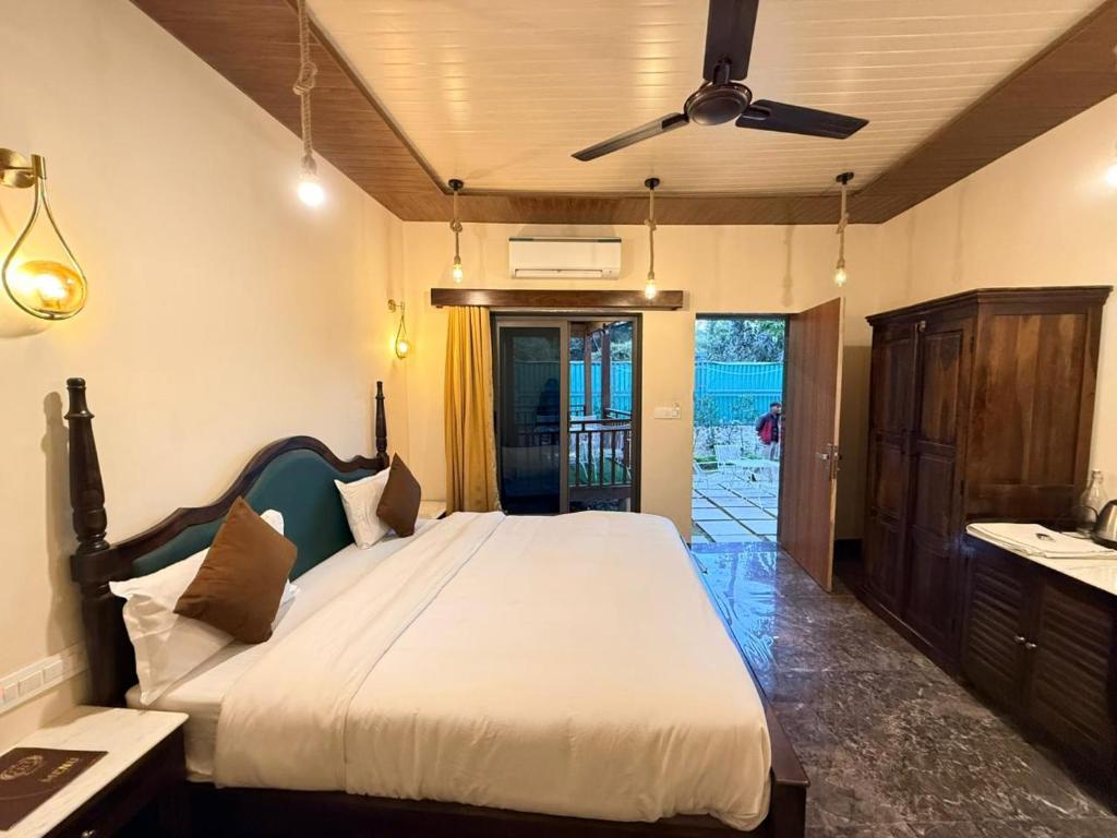 a bedroom with a bed and a ceiling fan at Royal cottage by royale palace in Mount Ābu