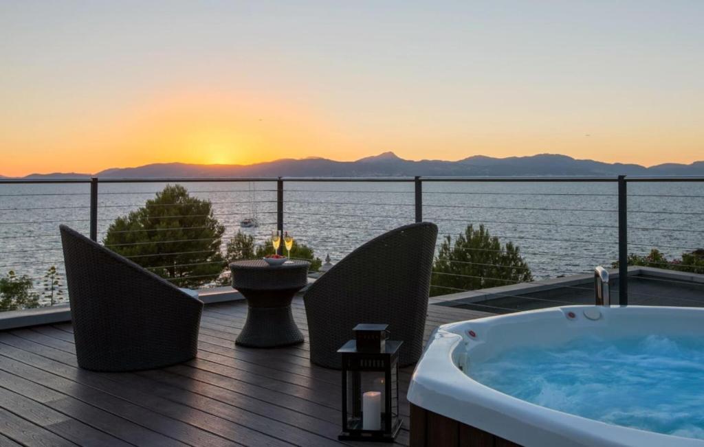 a bath tub on a deck with a view of the ocean at Robert Christopher Börner in Badia Gran