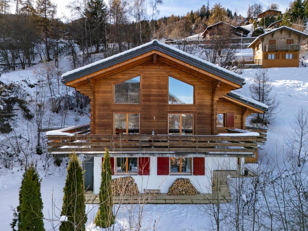 a log cabin in the snow with snow covered at Chalet Renard Roux in La Tzoumaz
