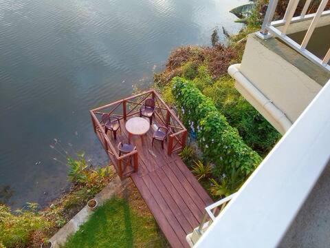 an overhead view of a table and chairs on a wooden deck at blu River villa Ambalangoda in Nikawatawana