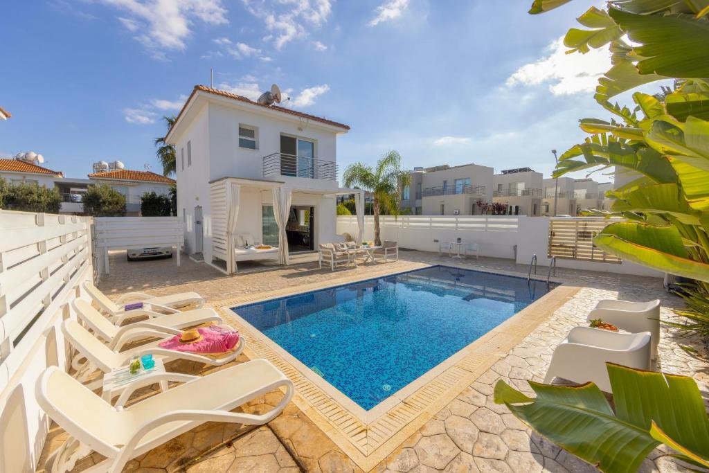 a villa with a swimming pool and a house at Protaras Villa Alina in Protaras