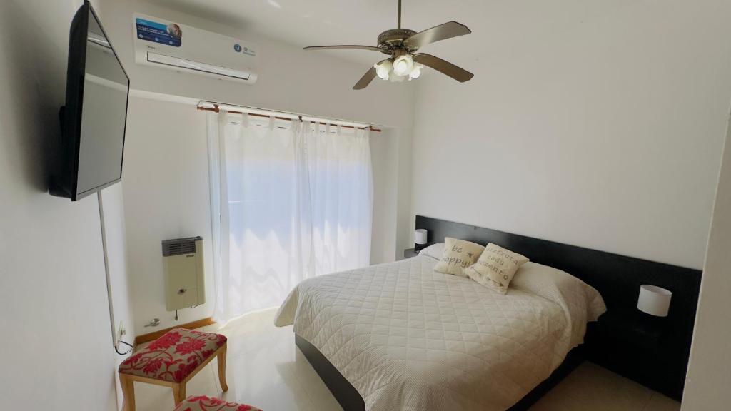 a bedroom with a bed and a ceiling fan at Mimi’s Dream Luján 2 in Luján