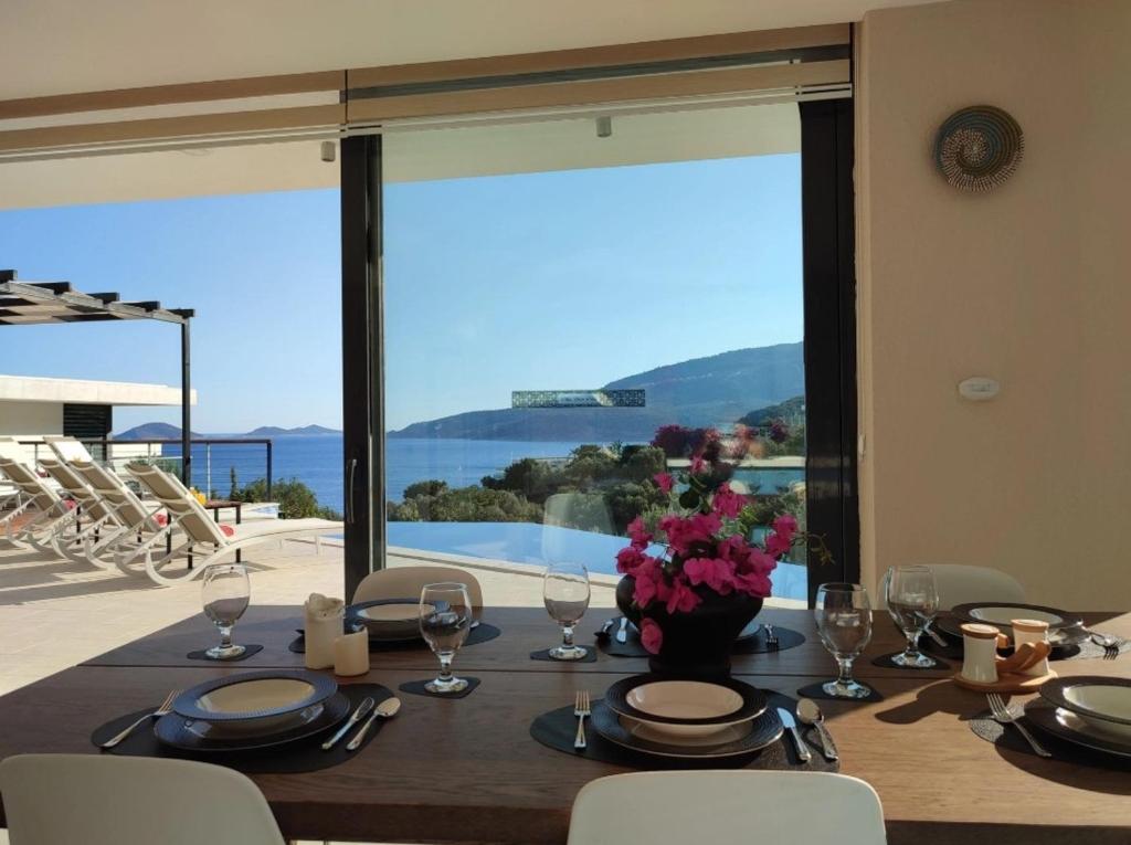 a dining table with a view of the water at Villa Ship Ahoy in Kaş