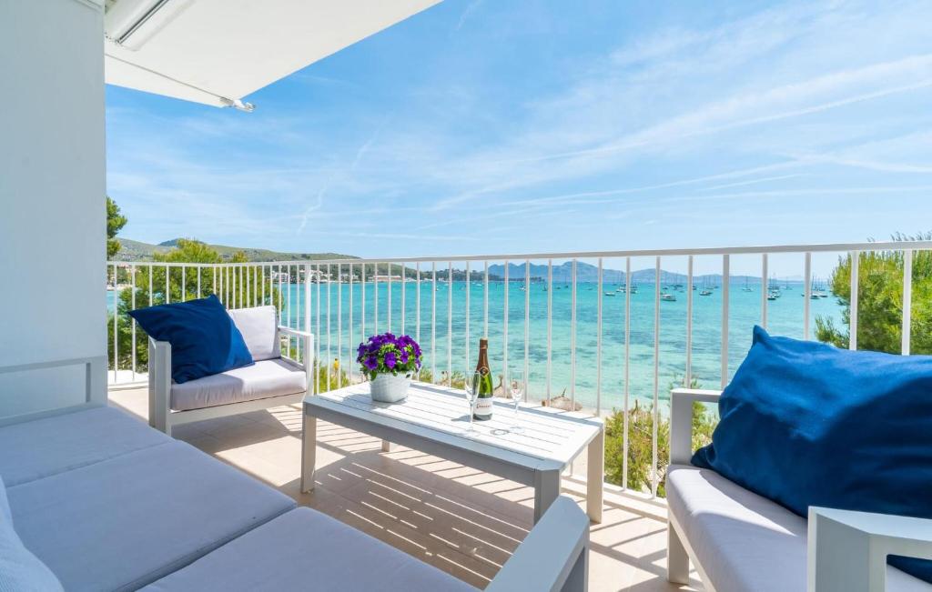 a patio with a table and a view of the ocean at Voramar On Pinewalk in Pollença