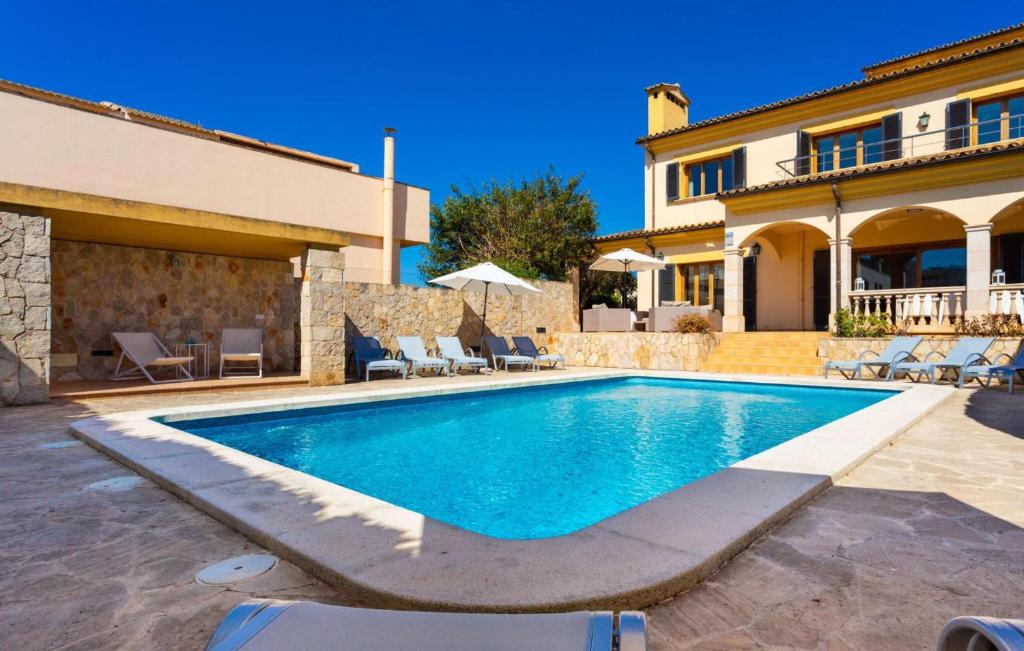 a swimming pool in front of a villa at Ca Nostra in Cala Millor