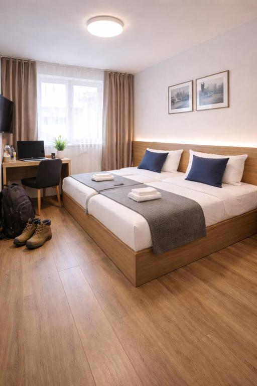 a bedroom with a large bed with blue pillows at Am Silbersee in Hochheim am Main
