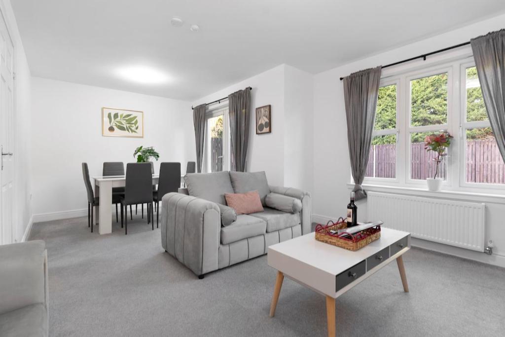 a living room with a couch and a table at Buie's Runway Retreat in EDI