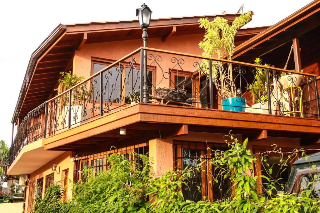 a building with a balcony with plants on it at Mama Africa Hostel in Florianópolis