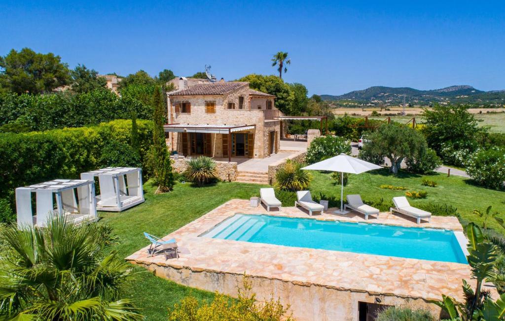an external view of a villa with a swimming pool at Son Artigues in Manacor