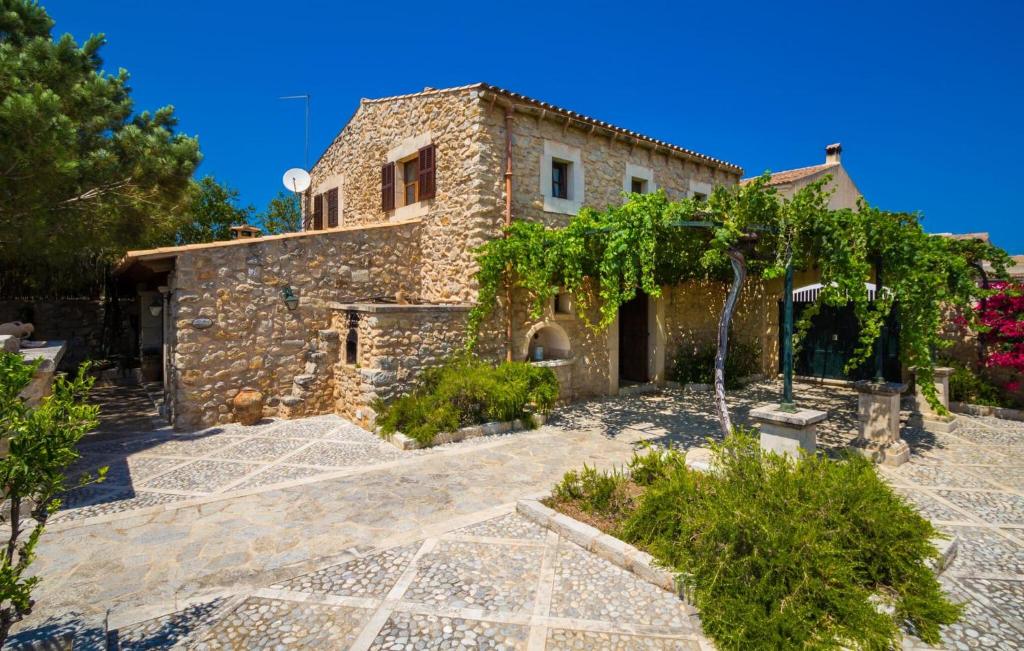 a stone house with a garden in front of it at Sos Monjos in Artá