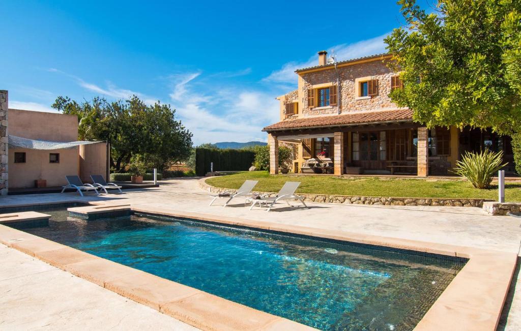 a house with a swimming pool in front of a house at Es Triquet in Binissalem