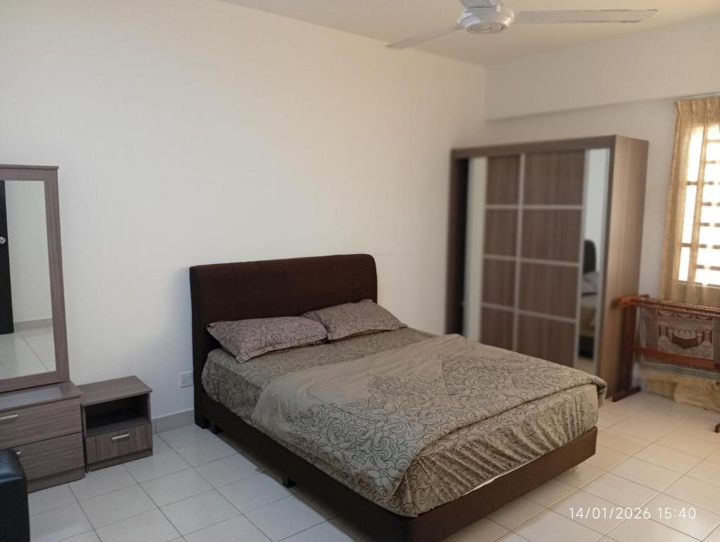 a bedroom with a bed and a dresser and a mirror at Seberang Jaya Family Pool Homestay Near Hospital 3 Bedroom Aircond 2 Bathroom & Family Room Aircond in Perai