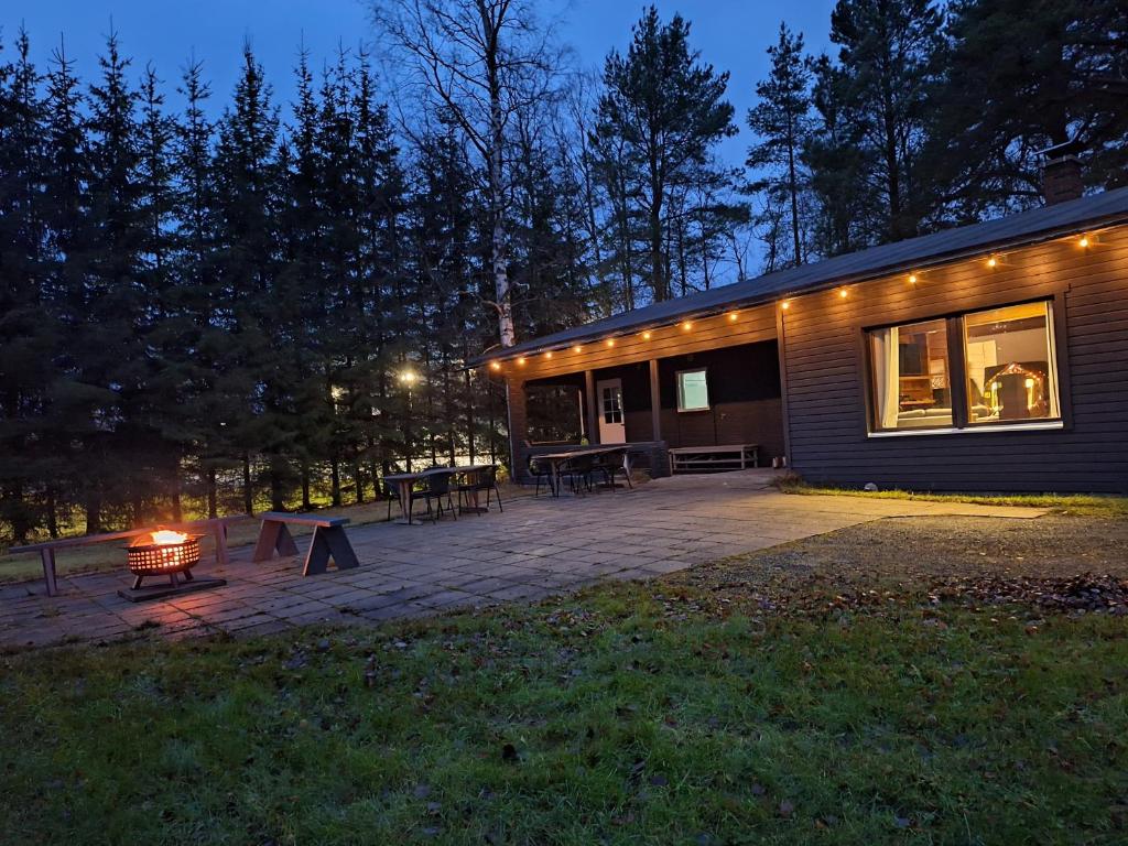 a house with a patio in front of it at night at Villa Irjala in Oulu