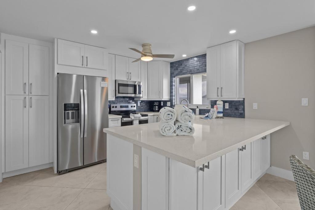 a kitchen with white cabinets and stainless steel appliances at Island Beach Club P4E in Sanibel
