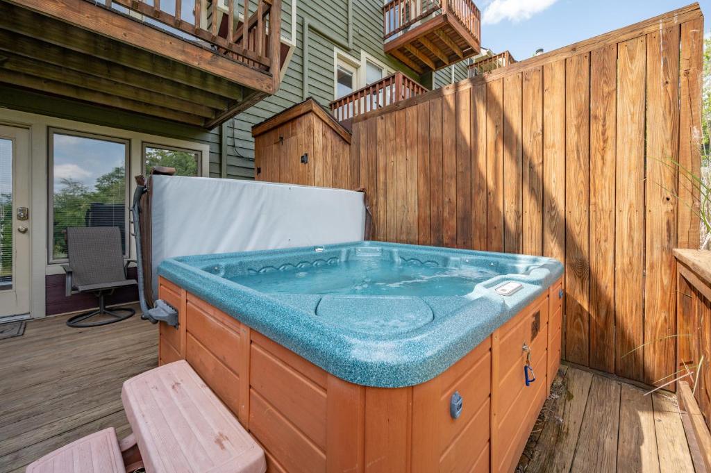 a jacuzzi tub on a deck with a house at Après 18 by Railey Vacations in McHenry