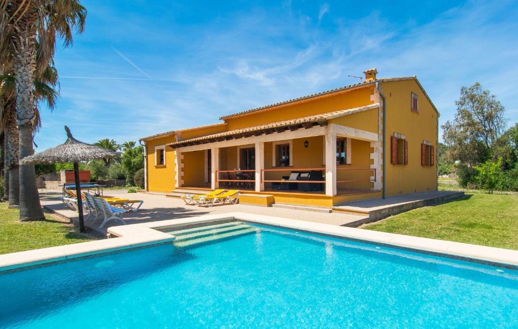 a villa with a pool in front of a house at Can Jaume Pollenca in Pollença