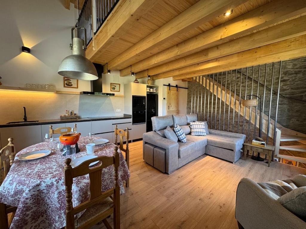 a living room with a table and a couch at Cal Not Celler, Cerdanya in Escardacs
