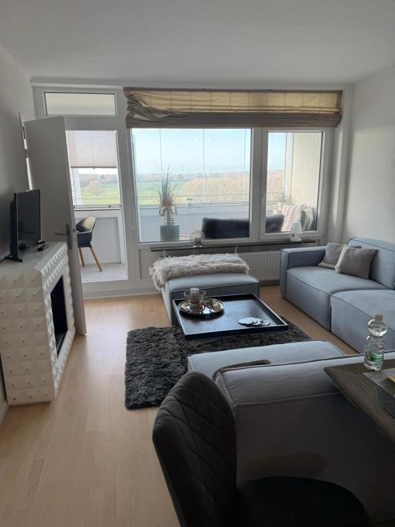 a living room with a couch and a tv at BeachPark Sierksdorf in Scharbeutz