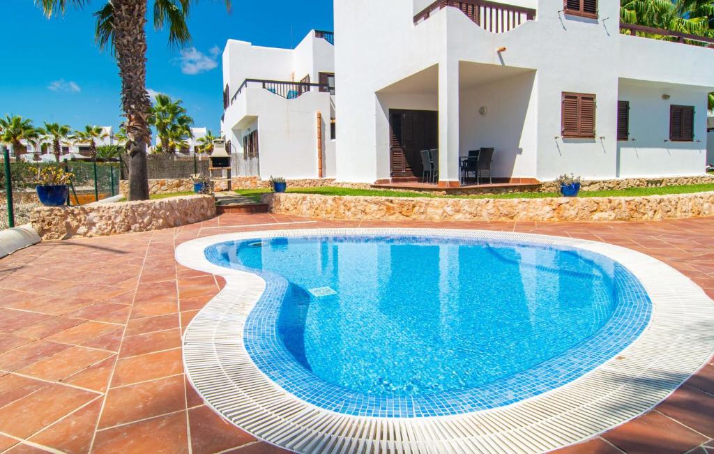 a swimming pool in front of a villa at Marina D'or Lv Casa 5 in Cala d´Or