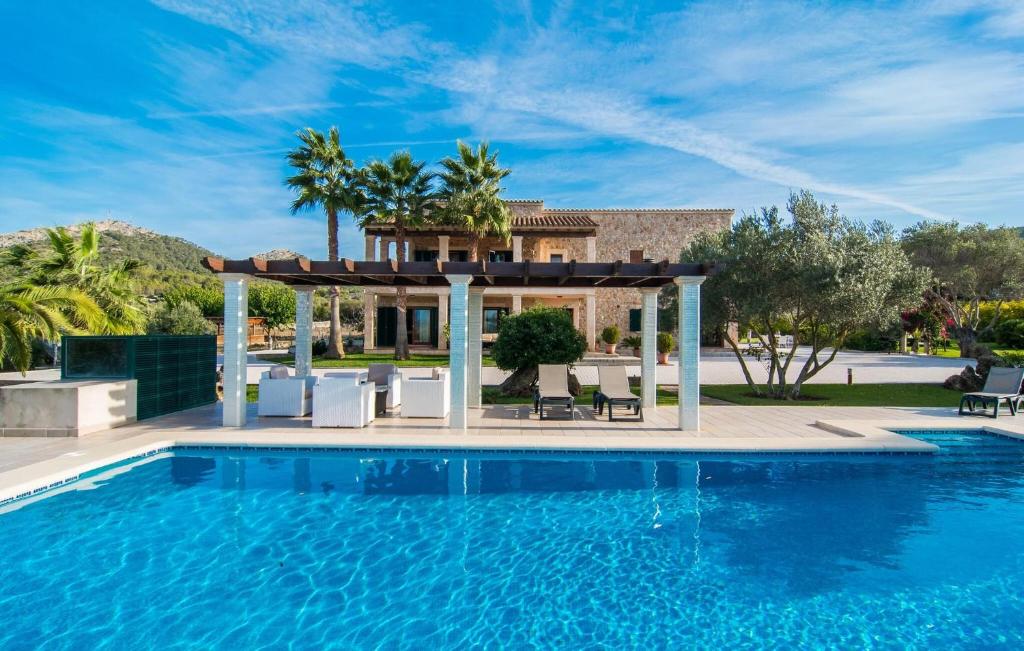 a pool with a gazebo next to a house at Ca Na Siona in Alcudia
