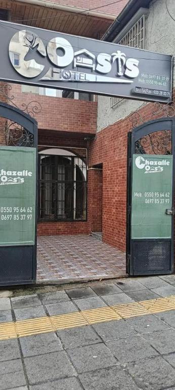 a store with a sign on the side of a building at Gazalle Oasis in El Biar