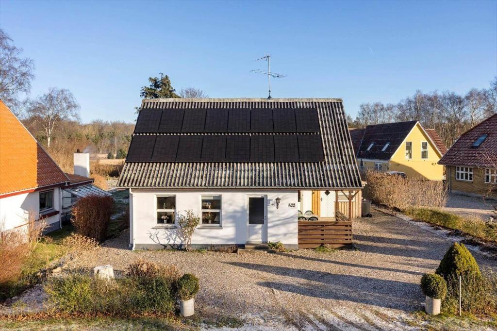 a small white house with a black roof at FY405-Millinge-Assensvej-422 in Faldsled