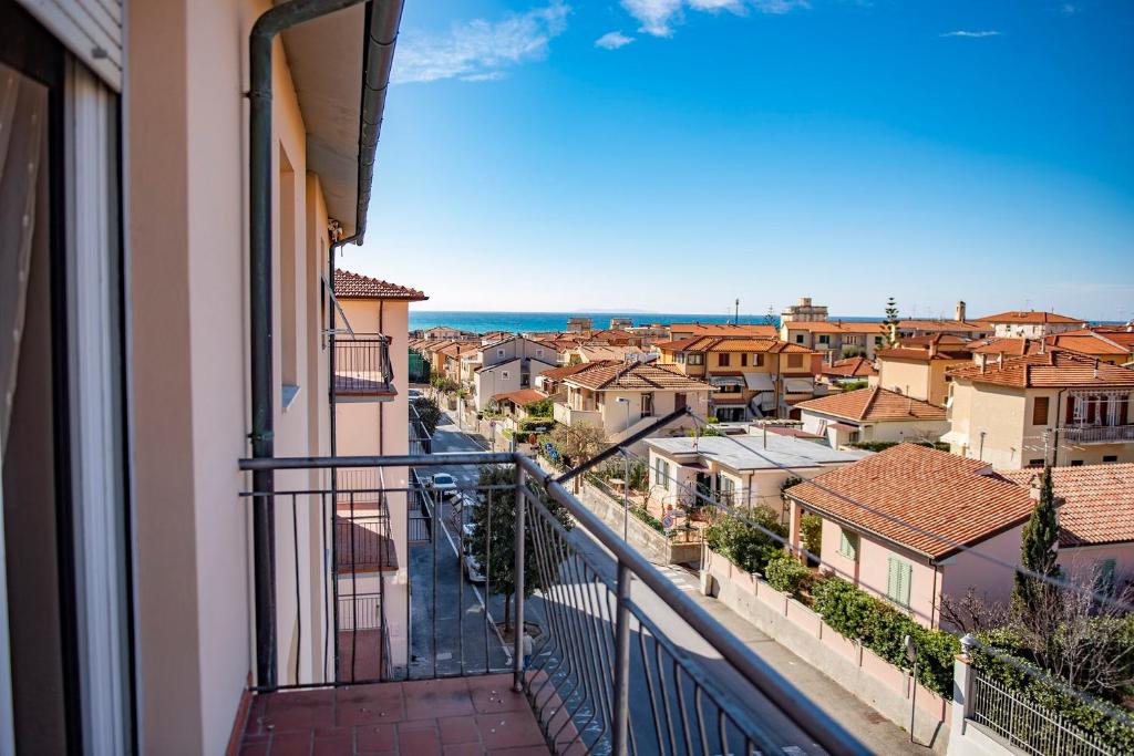 a balcony with a view of a city at Cav Costa degli Etruschi in San Vincenzo