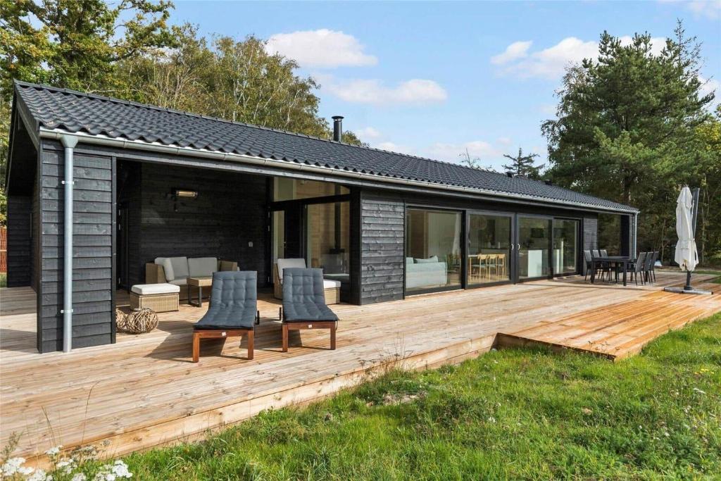 a house with a wooden deck with chairs on it at 10036-Rorvig-Magevej-11 in Rørvig