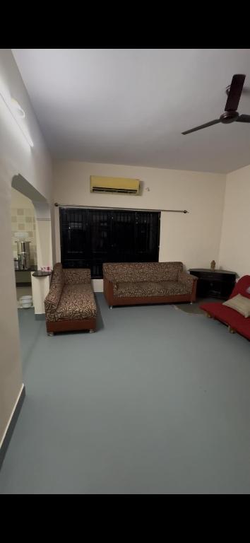 a living room with two couches and a couch at Offline Resort in Bengaluru, Karnataka