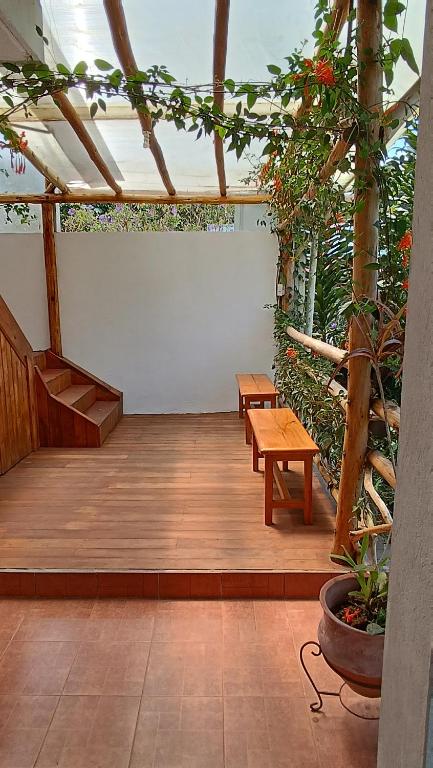 a patio with two benches and a table at Mindo Suites - Rufous in Mindo