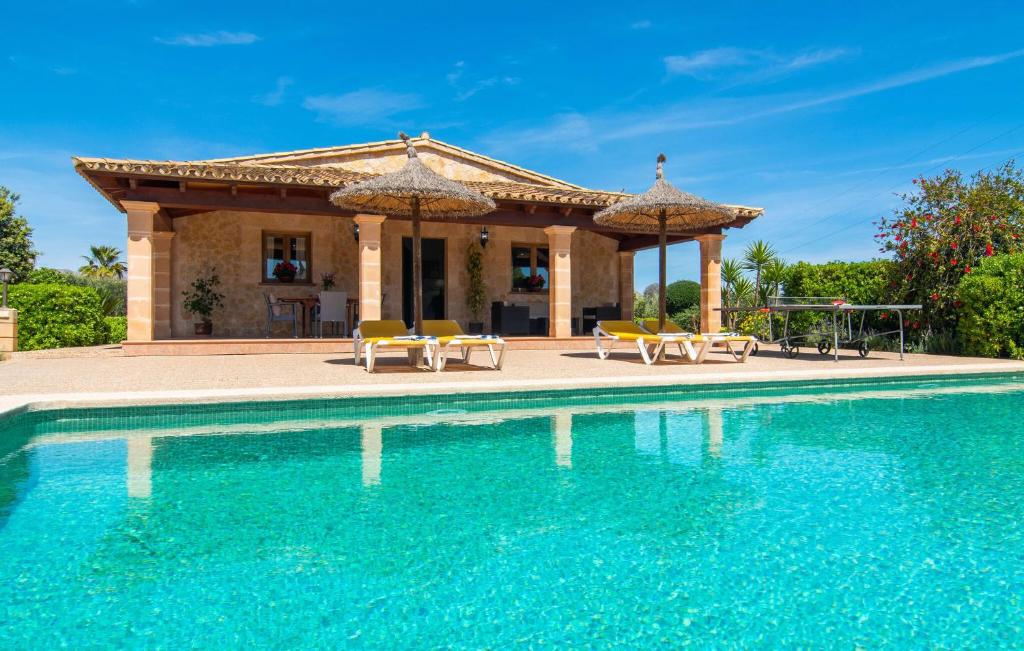 a villa with a swimming pool and a gazebo at Ca Na Neus Pollenca in Pollença