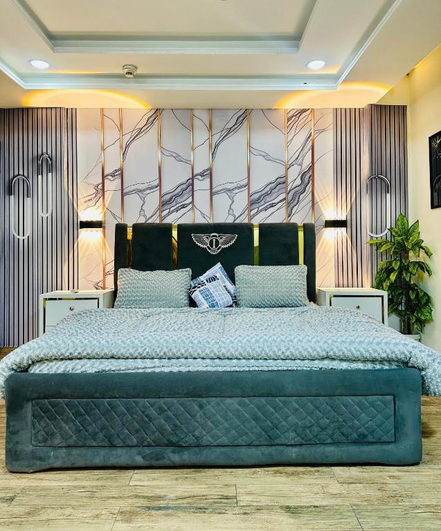 a bedroom with a large bed in a room at Modern City Escape Bahria hieghts in Rawalpindi