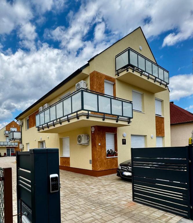 a house with a balcony on top of it at M21 Residence Sárvár in Sárvár