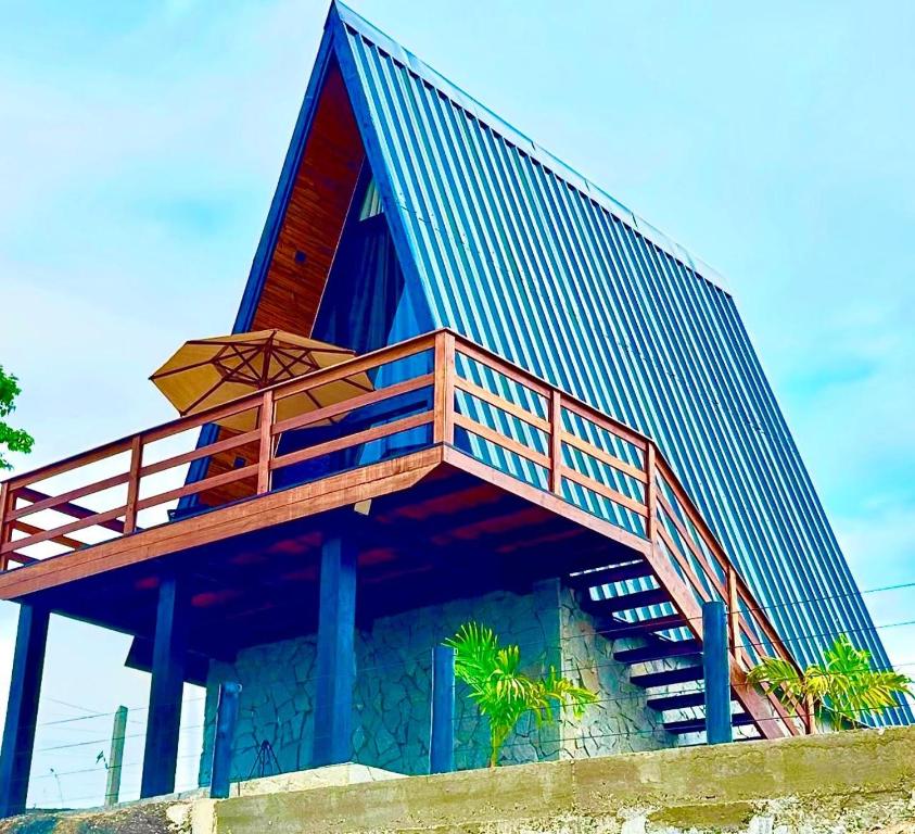 a building with a deck on the side of it at Fabulosas da Serra in Monte das Gameleiras